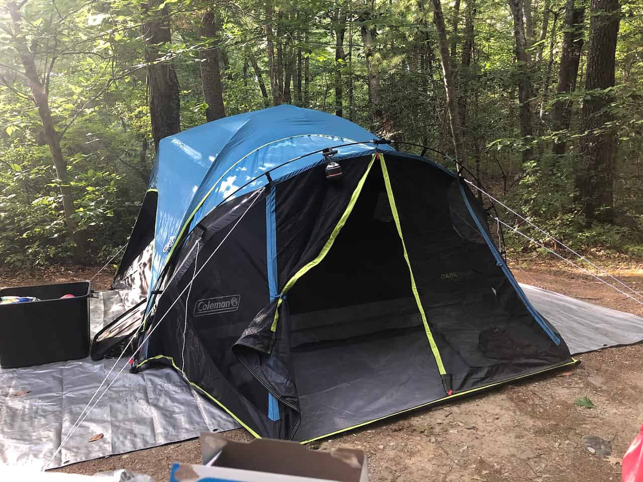 A camping setup with a tent and gear at a campsite
