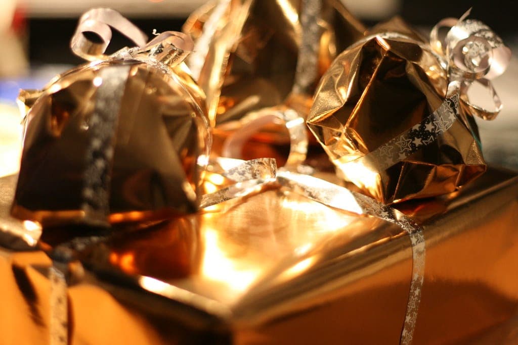Camping gear and gift wrapping laid out on a table