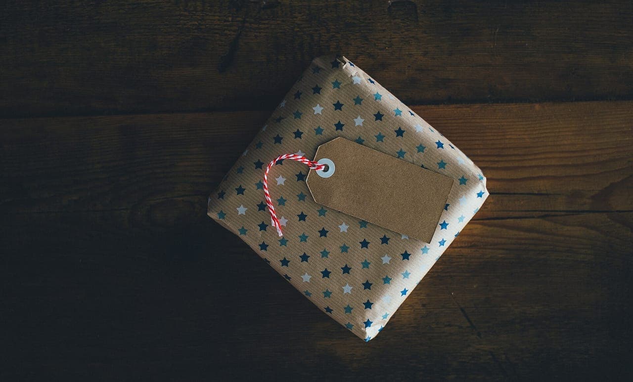 A small wrapped gift box on a plain surface