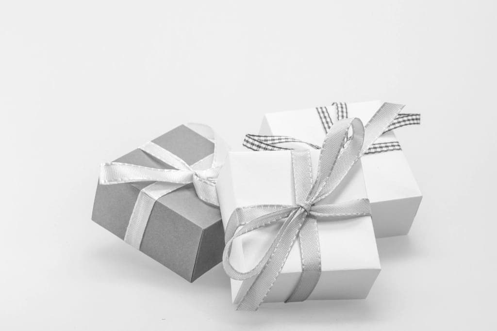Travel accessories and a wrapped gift on a desk