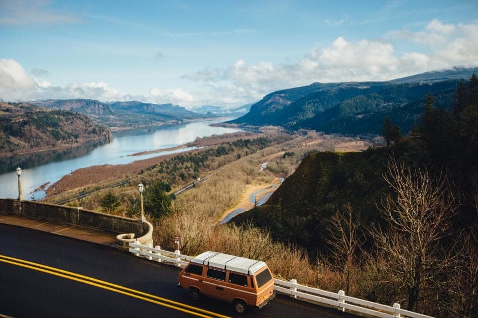 A car parked at a roadside overlook on a long drive