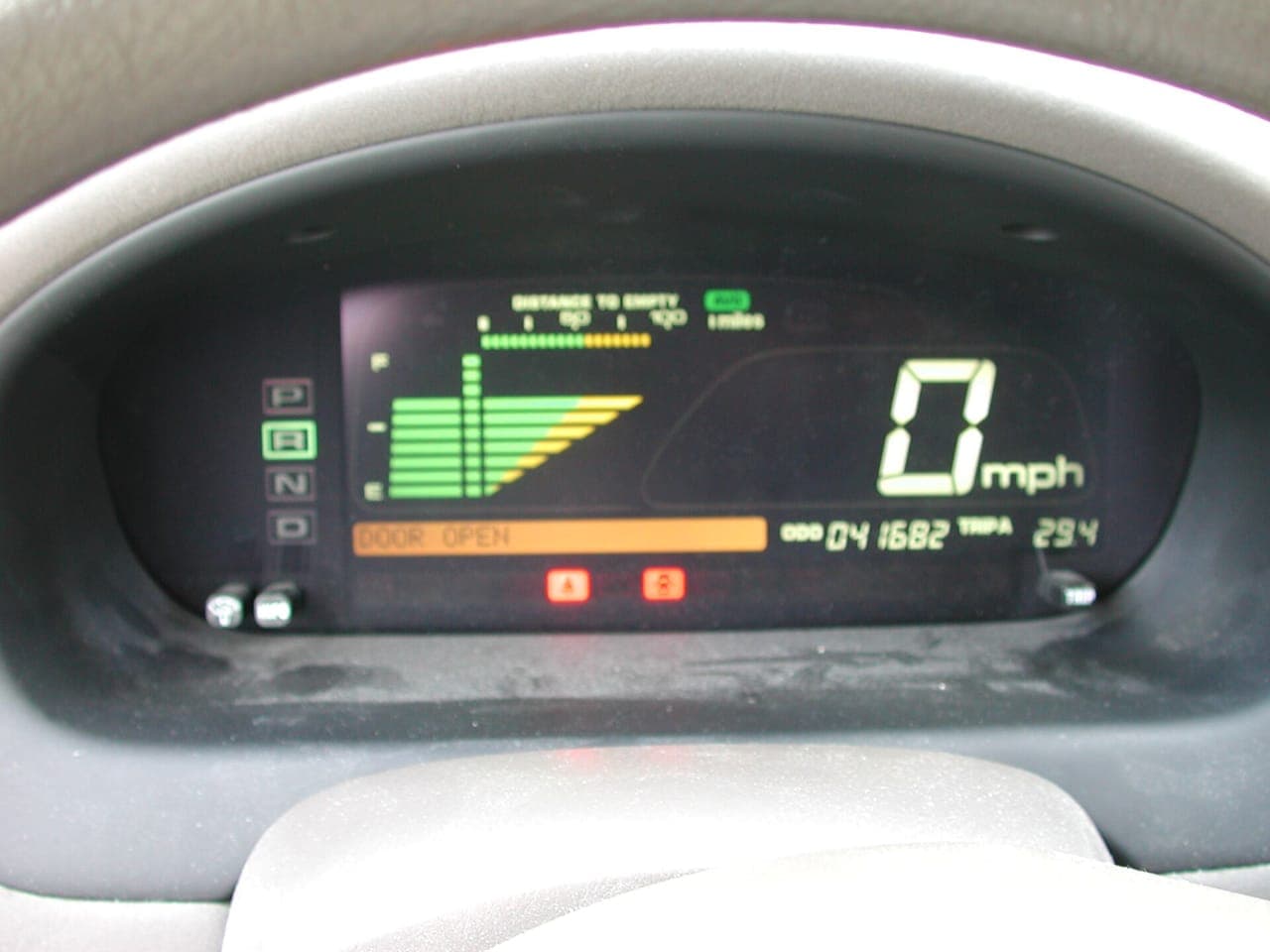 A phone mounted on a car dashboard showing a navigation map