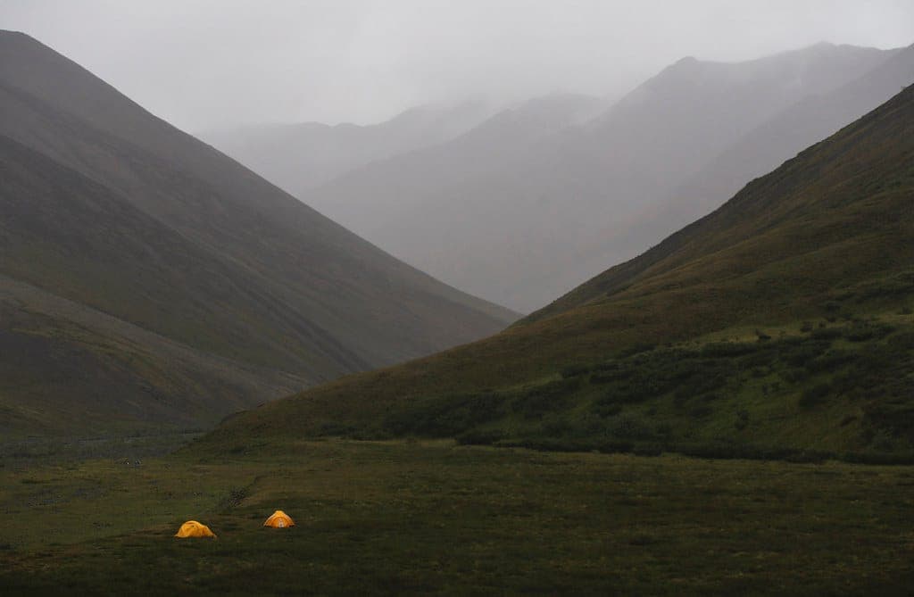 A sleeping bag laid out on a pad inside a tent