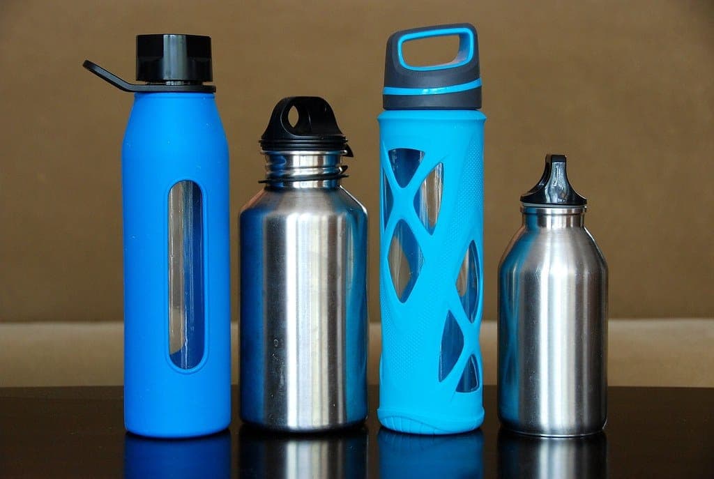Three insulated stainless steel bottles standing side by side